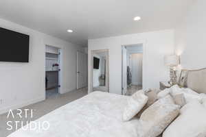 Carpeted bedroom with a spacious closet, recessed lighting, and connected bathroom