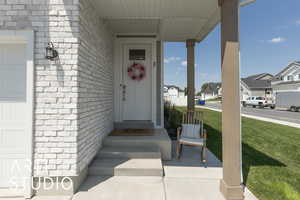 Property entrance featuring a residential view and a lawn