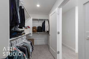 Spacious closet with carpet floors