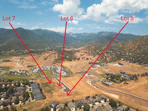 Aerial view of property's location with a mountain backdrop and nearby suburban area