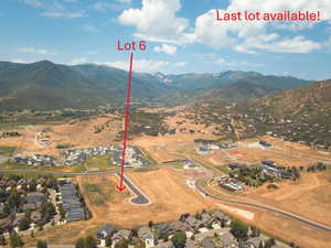 Aerial overview of property's location with nearby suburban area and mountains