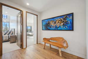 Hallway featuring light wood-type flooring and recessed lighting