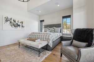 Bedroom with multiple windows, light wood-type flooring, and recessed lighting