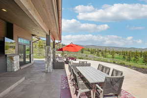 View of patio featuring a mountain view, outdoor dining area, and an outdoor living space