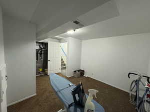 Exercise area featuring carpet and baseboards