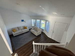 Living area with wood finished floors and a textured ceiling