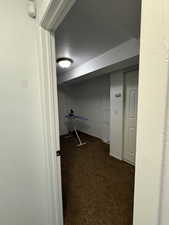 Spacious closet with dark colored carpet