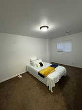 Carpeted bedroom with baseboards