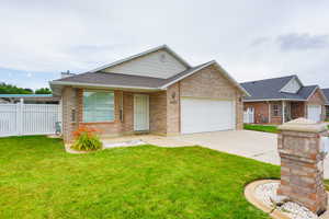 Ranch-style house with a shingled roof, an attached garage, brick siding, and driveway