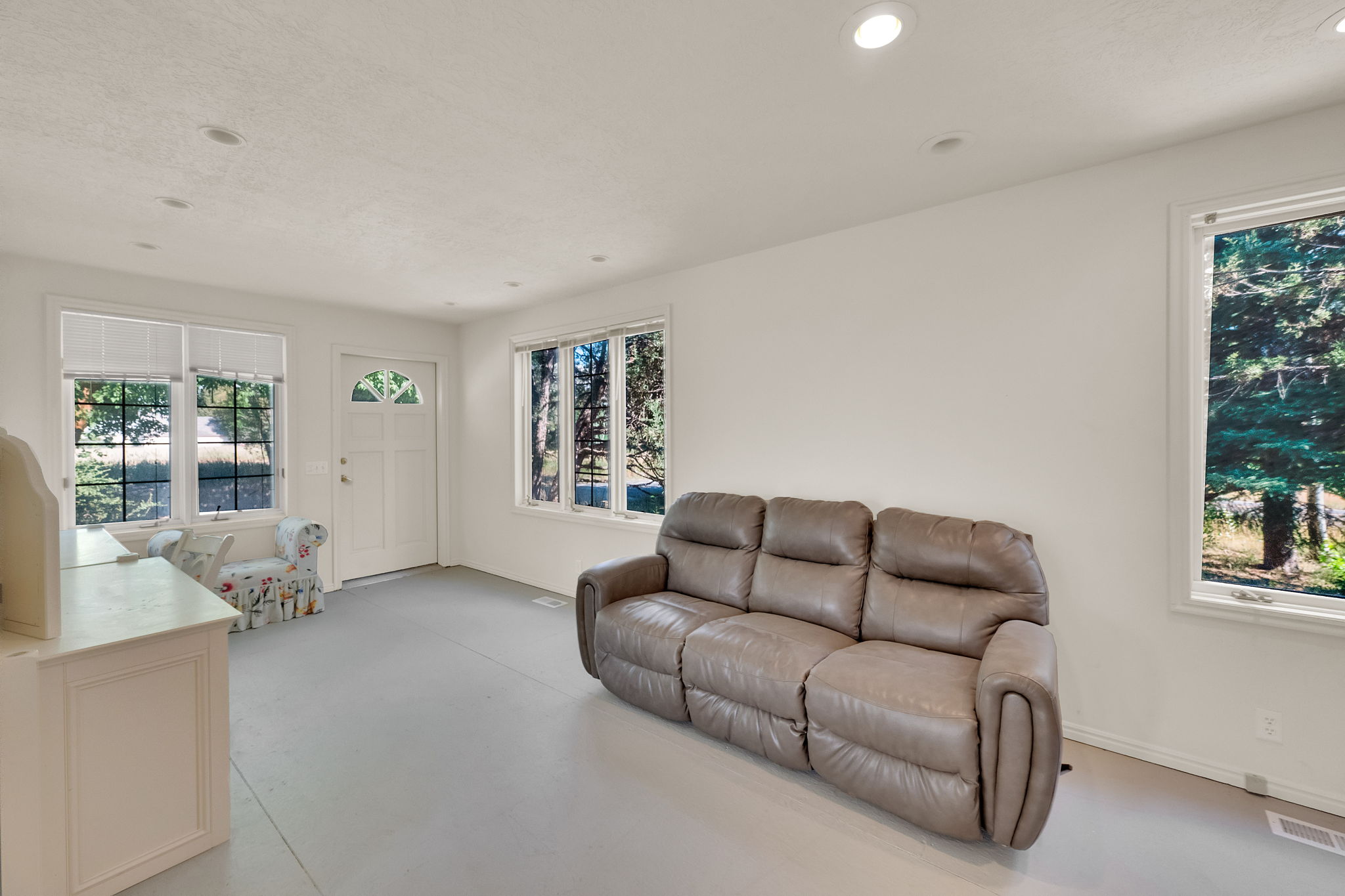 Living area featuring healthy amount of natural light, concrete floors, and recessed lighting