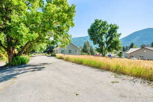 View of asphalt street featuring a mountain view