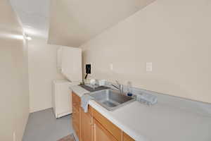 Kitchen with a sink and light countertops