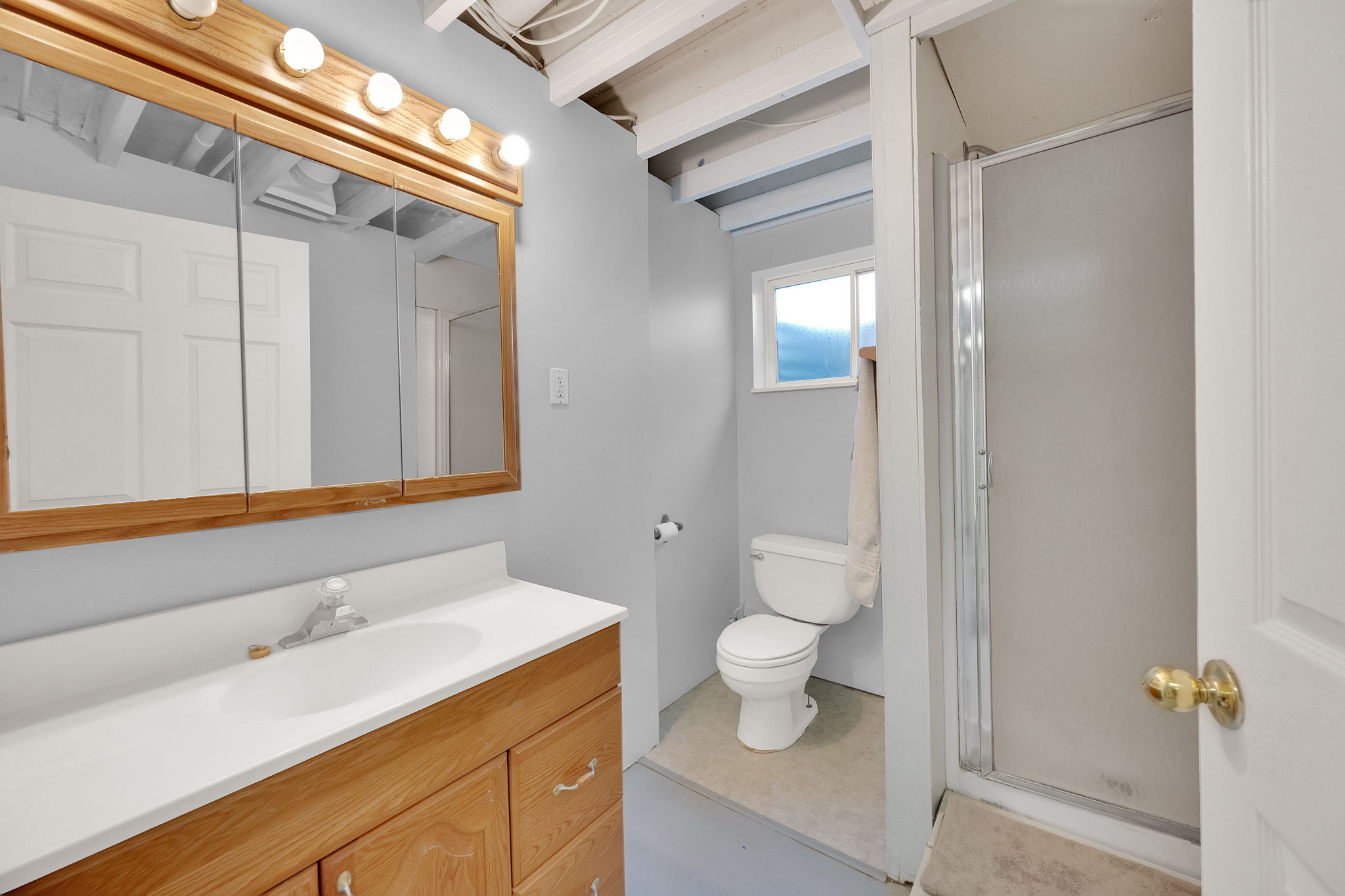 Bathroom featuring vanity and a stall shower
