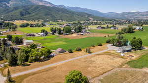 Overview of rural landscape featuring a mountain backdrop