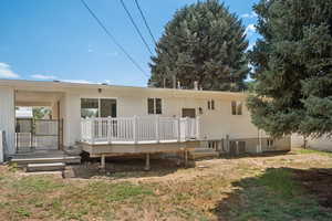 Back of property with a deck