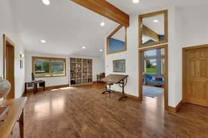 Entrance foyer with beam ceiling, recessed lighting, wood finished floors, and high vaulted ceiling