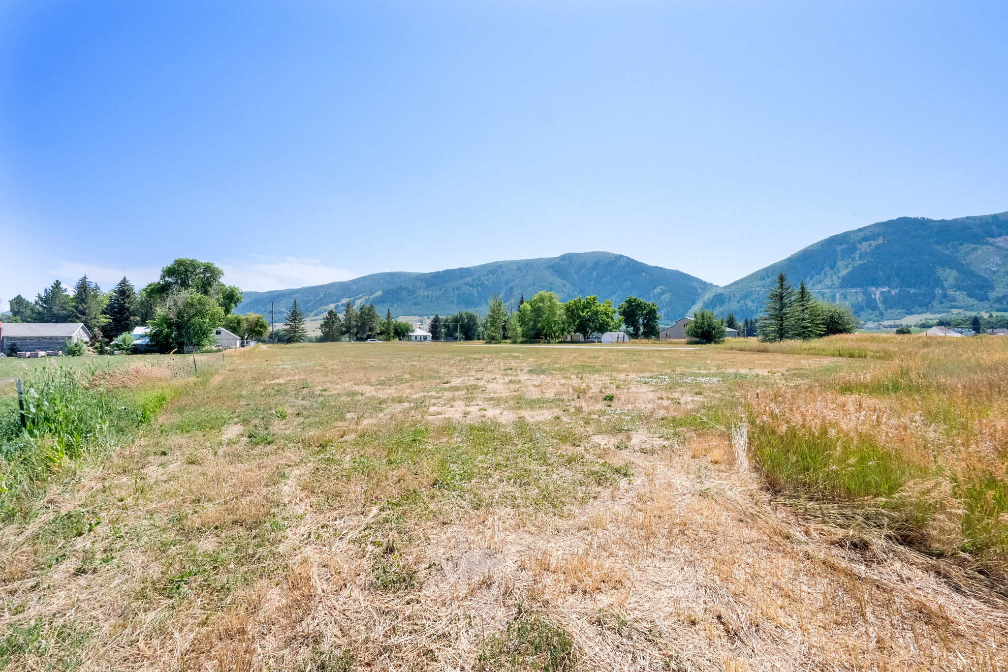 View of mountain backdrop featuring rural landscape