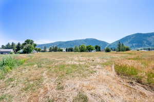 View of mountain backdrop featuring rural landscape