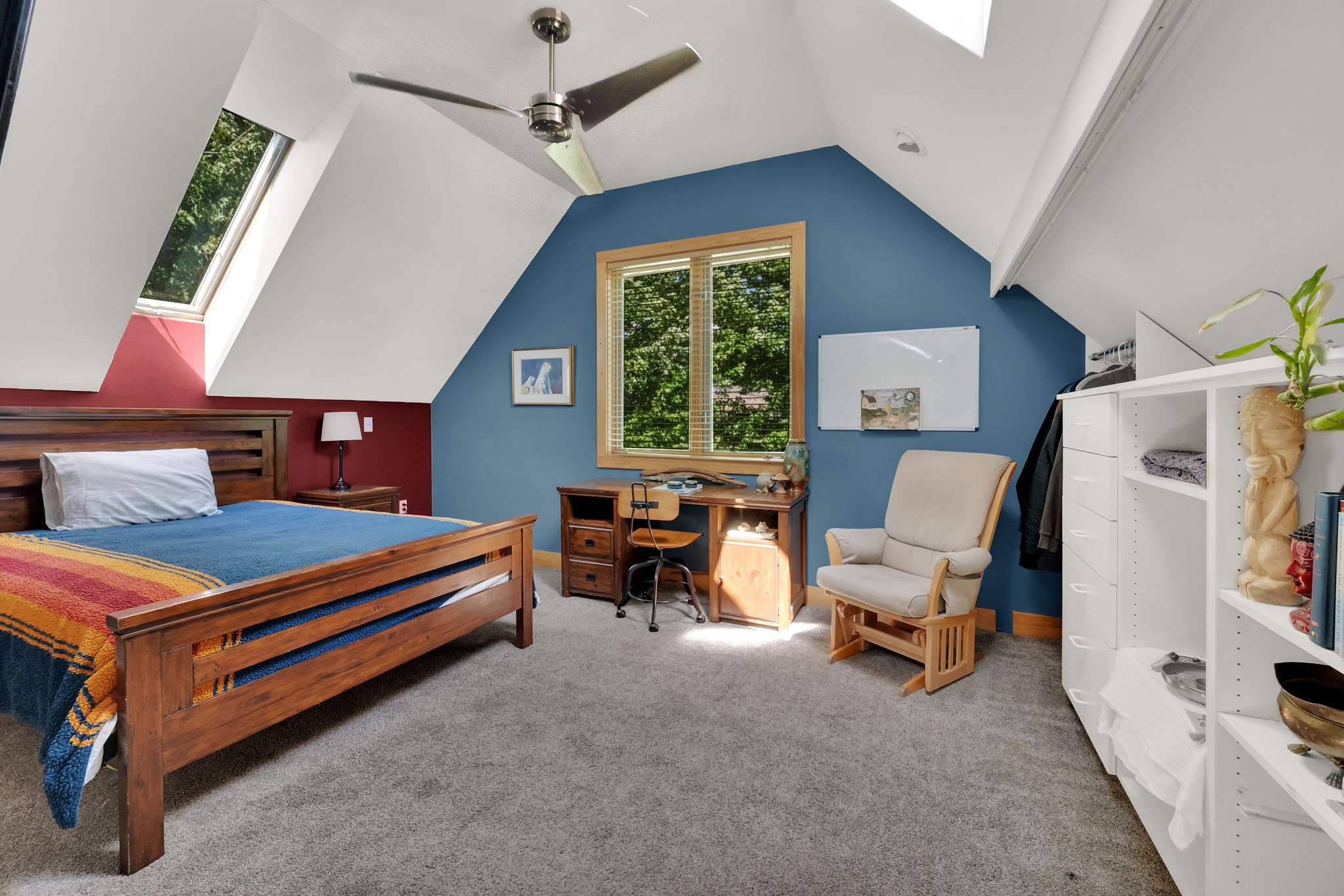 Bedroom with a skylight, carpet flooring, lofted ceiling, an office area, and ceiling fan