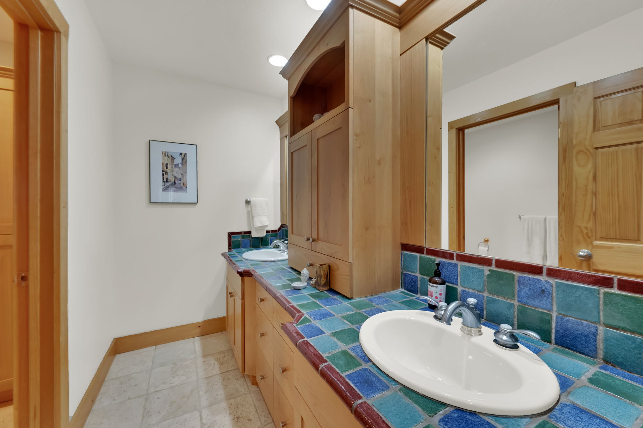 Bathroom featuring double vanity and tasteful backsplash