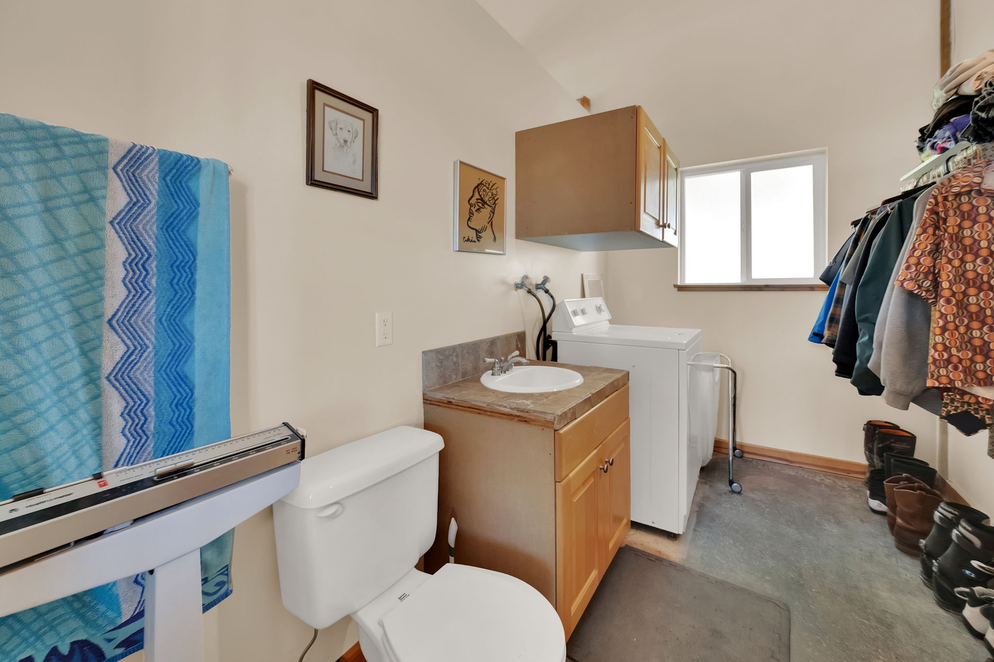 Bathroom with washing machine and clothes dryer and vanity