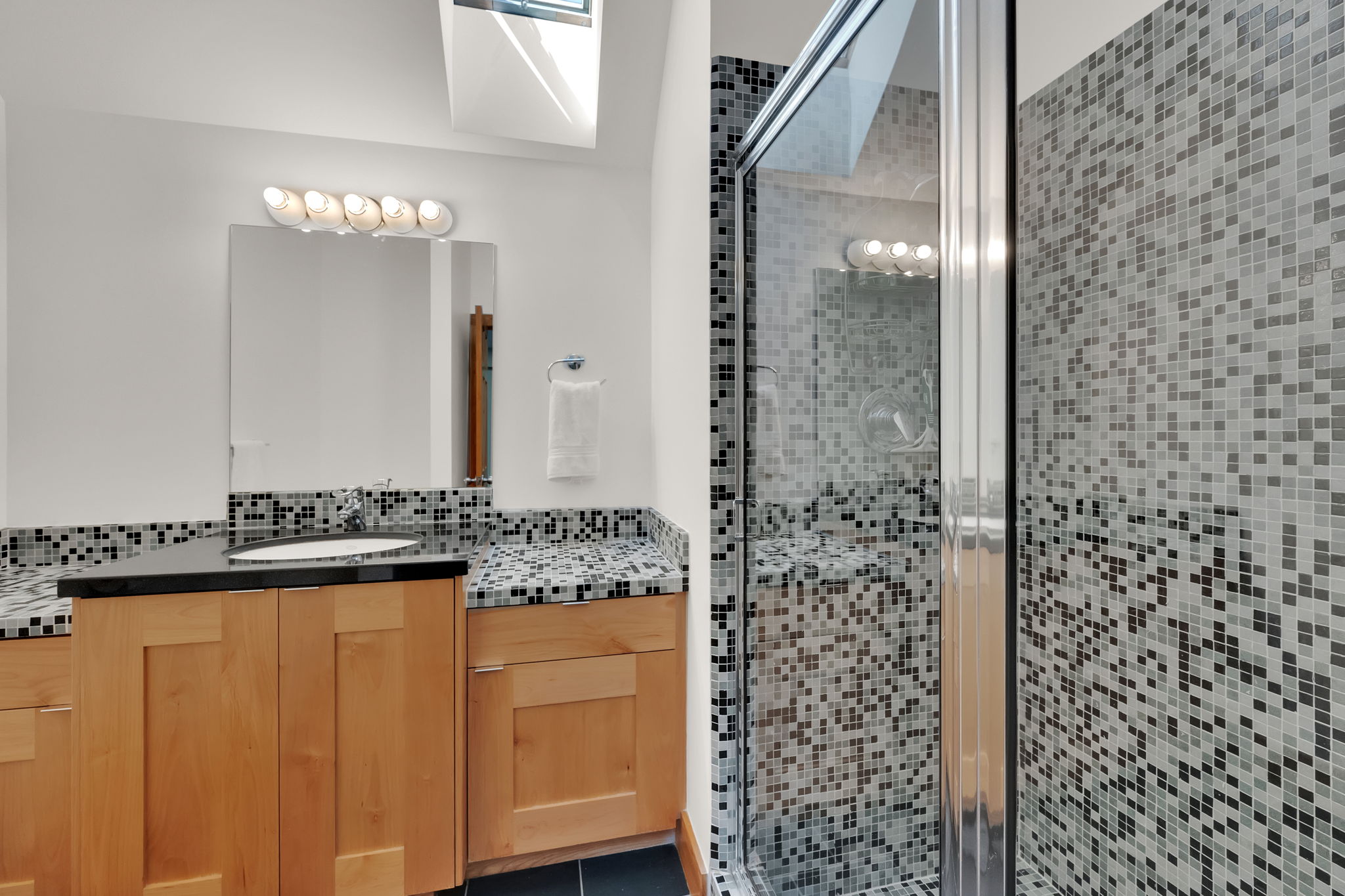 Full bathroom featuring vanity, a shower stall, and decorative backsplash