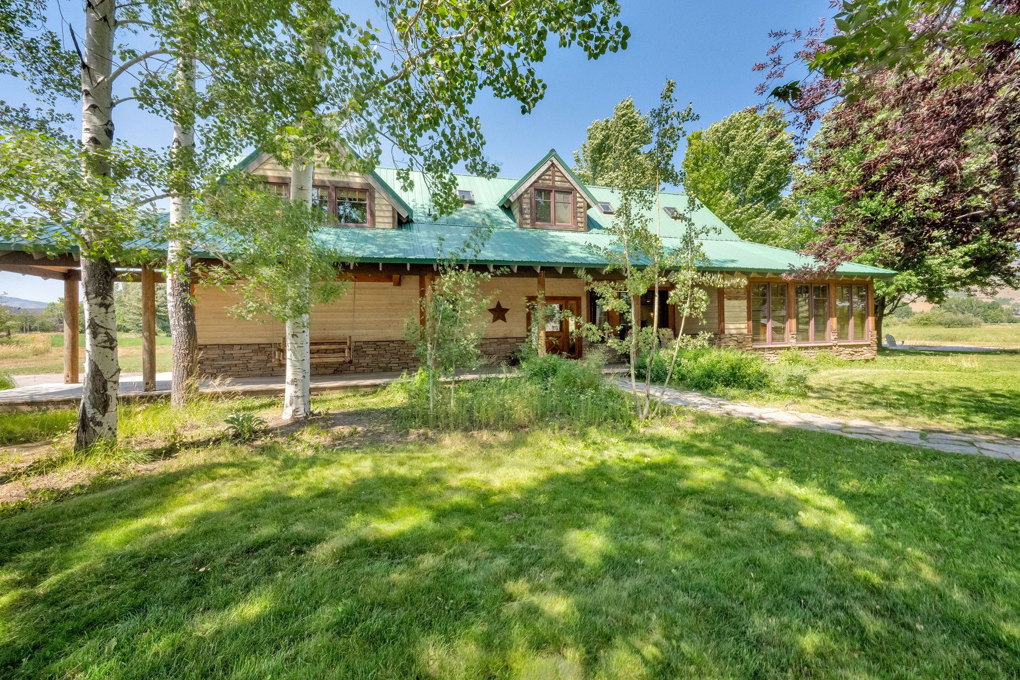Farmhouse-style home featuring a front lawn