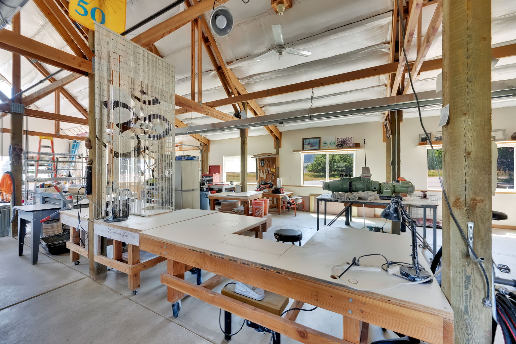 Dining space featuring concrete flooring and a workshop area