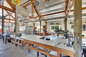Dining space featuring concrete flooring and a workshop area