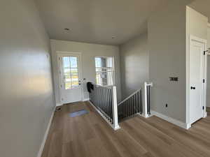 Entrance foyer with wood finished floors and baseboards