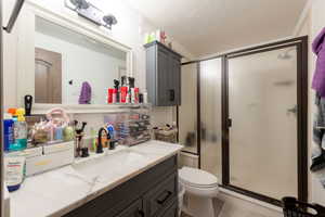 Bathroom with vanity and a shower stall