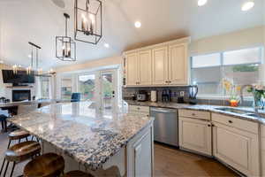 Kitchen featuring a chandelier, dishwasher, plenty of natural light, dark wood-style floors, and recessed lighting