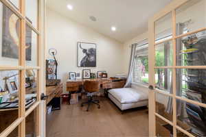 Office space featuring vaulted ceiling, light wood-style flooring, recessed lighting, and french doors