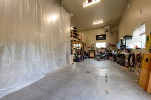 Garage with a heating unit and a workshop area