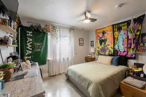 Bedroom featuring concrete floors and ceiling fan