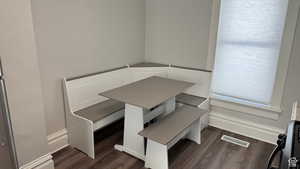 Unfurnished dining area with dark wood-style floors