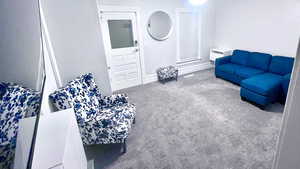 Carpeted living area with baseboards