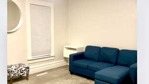 Living area featuring carpet floors and baseboards