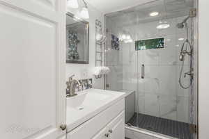 Main Bathroom - tile floors, glass enclosure, linen storage cabinets