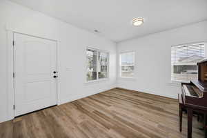 Foyer featuring wood finished floors and baseboards
