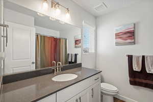 Bathroom with vanity and curtained shower