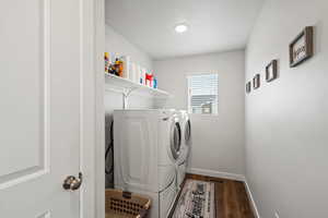 Washroom featuring washer and clothes dryer, a textured ceiling, and dark wood-style floors