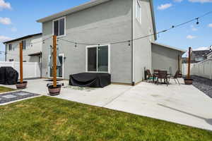 Back of property featuring a fenced backyard, a patio area, and stucco siding