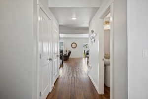 Hallway with dark wood-style flooring and a textured ceiling