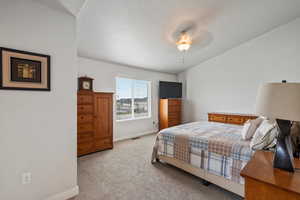 Bedroom featuring light colored carpet and a ceiling fan