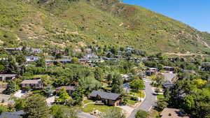 Aerial view of property's location featuring nearby suburban area and a mountainous background