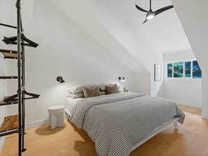 Bedroom 2 featuring vaulted ceilings, open shelving and a ceiling fan