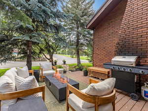 Deck with grilling area and an outdoor living space with a fire pit