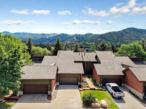 View of front facade featuring a brand new roof, mountain views, driveway, and garage