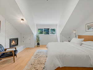 Primary bedroom featuring gas fireplace, two small storage nooks, and sitting area
